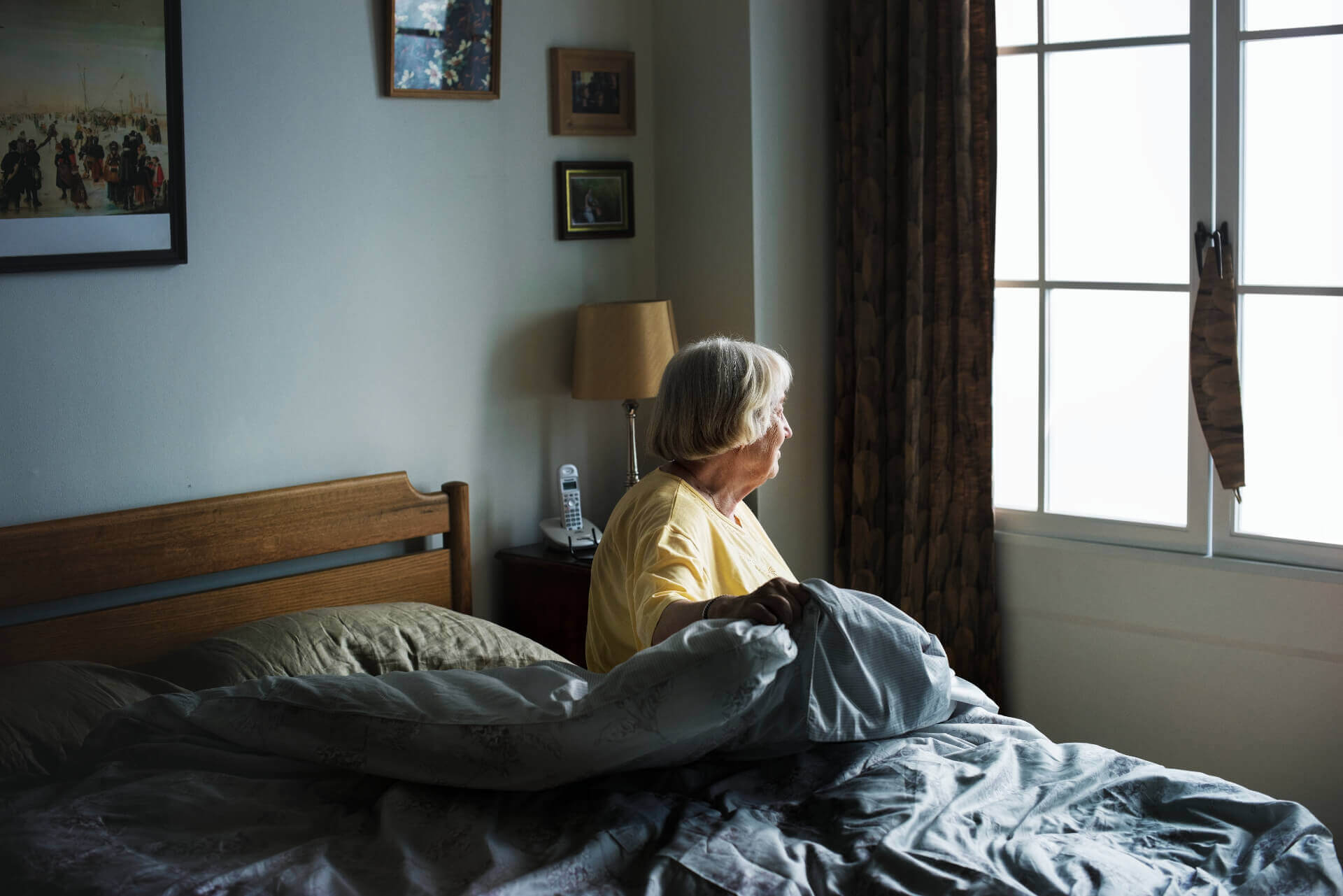 senior-woman-sitting-in-a-bedroom-PEDTMXQ Minute Women Home Care - live-in care, senior care, home health care lexington, concord, cambridge, somerville, boston, newton, belmont